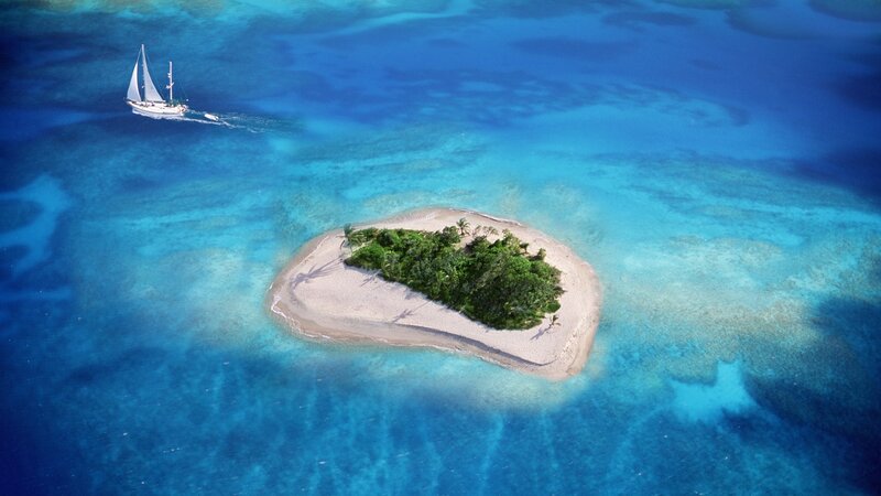 Sailboat near tropical island
