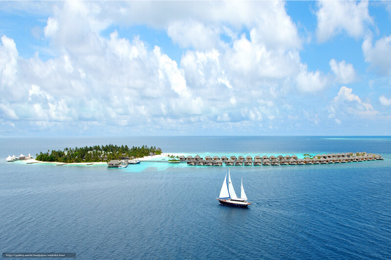 Sailboat near tropical island resort