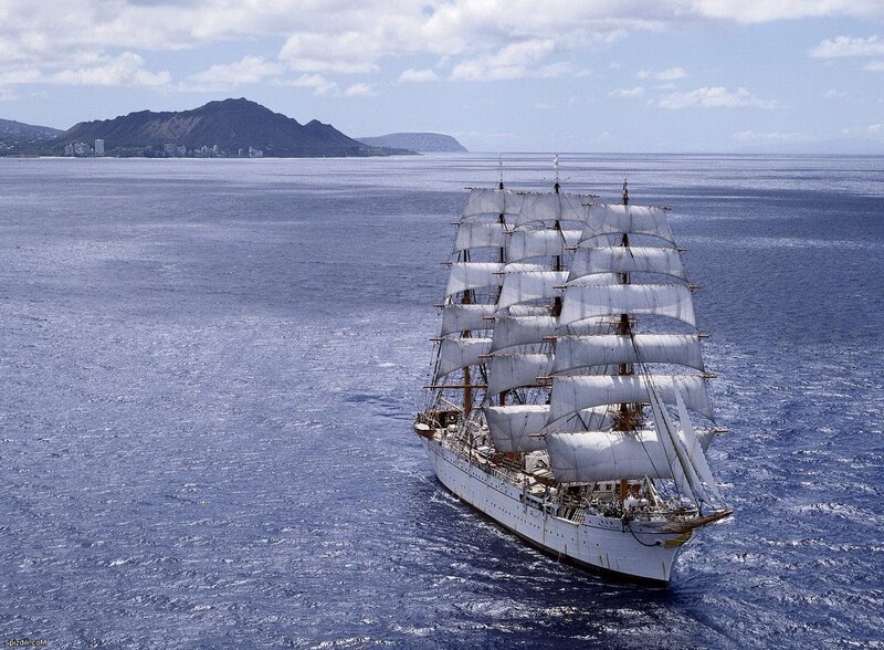 sailboat near volcanic island