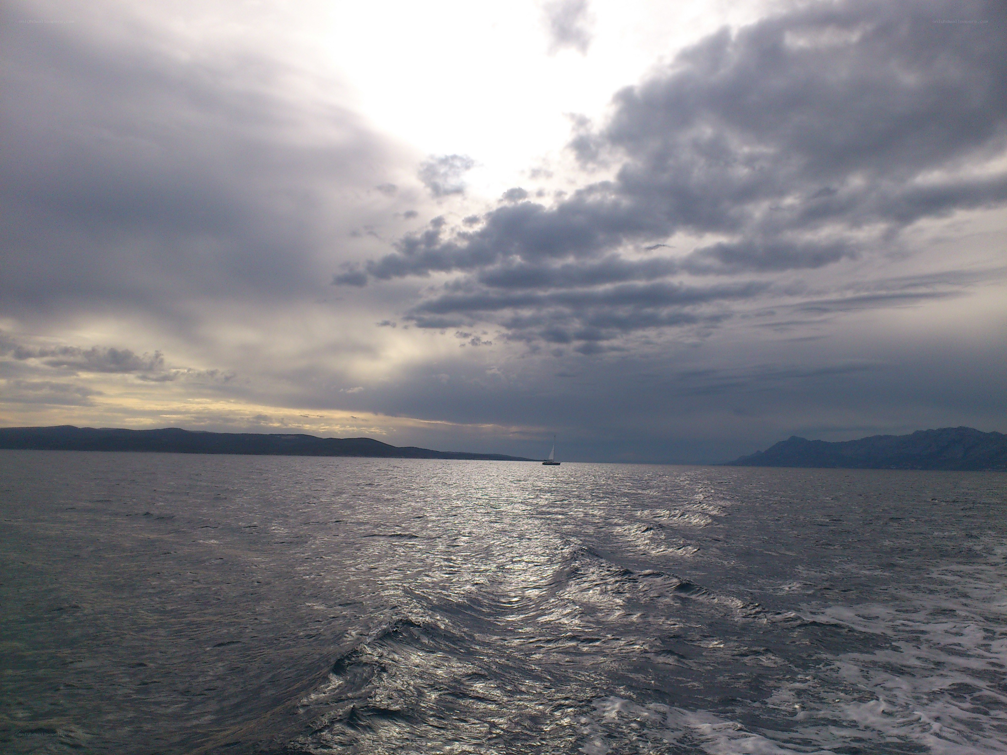 Sailboat on a cloudy sea
