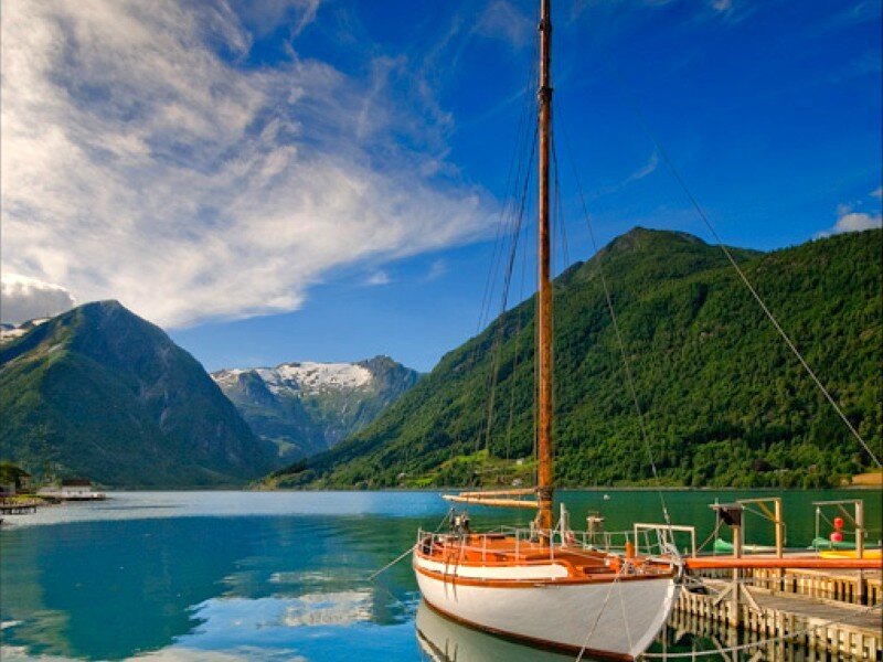 Sailboat on a fjord with mountains