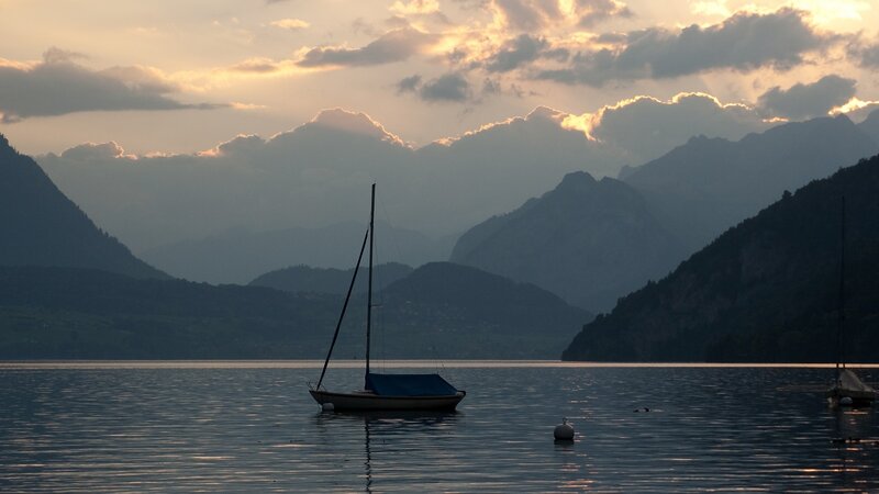 Sailboat on a Lake — Blue, Serene, Sunset
