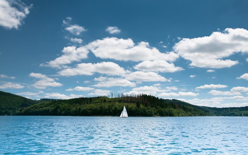 Sailboat on a lake with hills