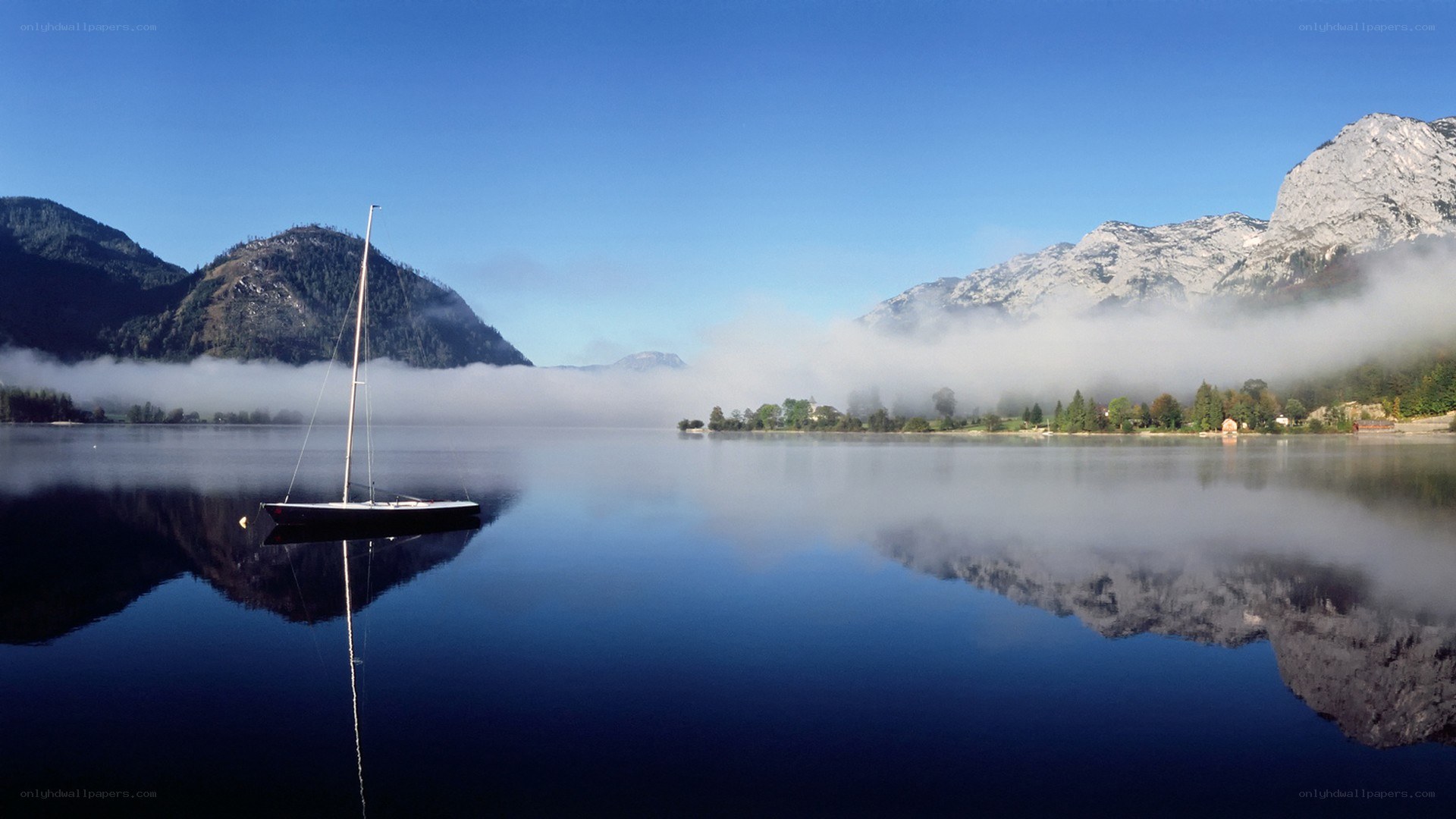 sailboat on a misty lake