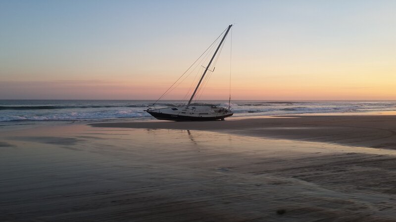 Sailboat on Beach — Blue, Serene, Sunset, Photograph, Ocean