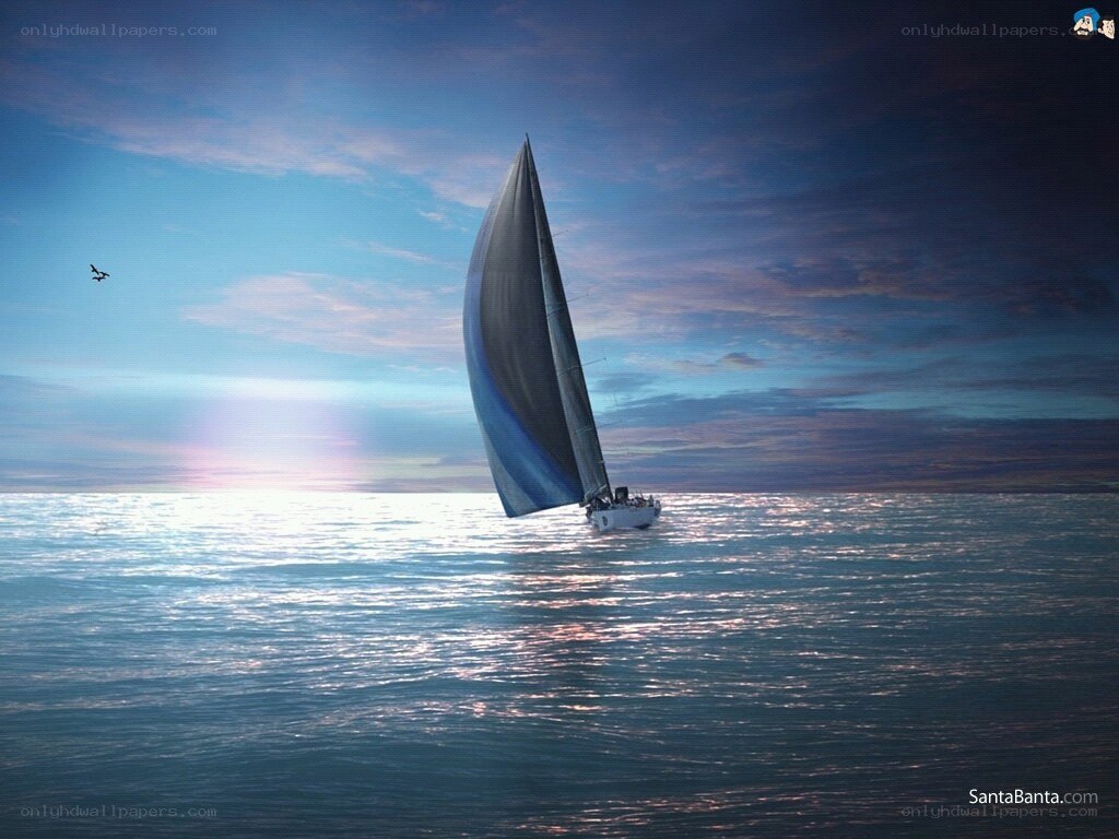 Sailboat on calm ocean at sunset