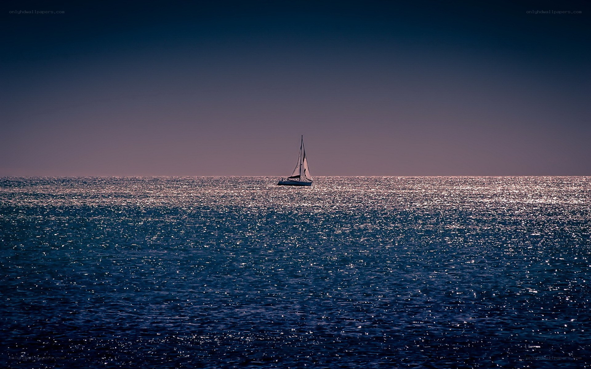 Sailboat on calm sea at dusk