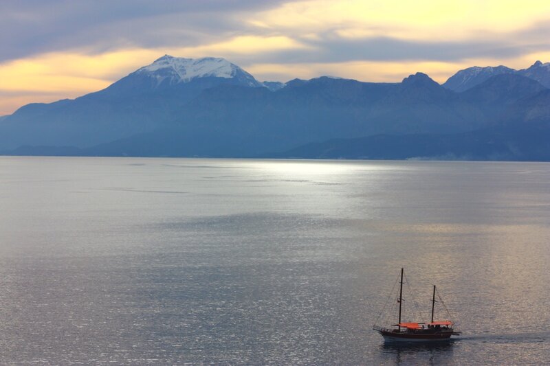 sailboat on calm sea at sunset