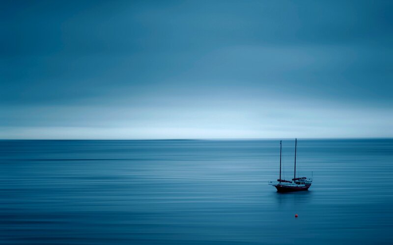 Sailboat on Calm Sea — Blue, Serene, Photograph