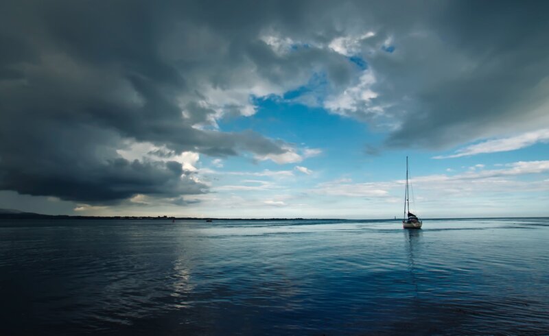 Sailboat on Calm Water — Blue, Dramatic, Photograph