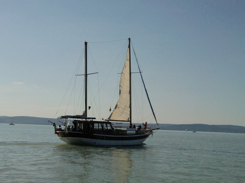 Sailboat on Calm Water — Blue, Serene, Afternoon, Photograph, Sail, People, Mountains