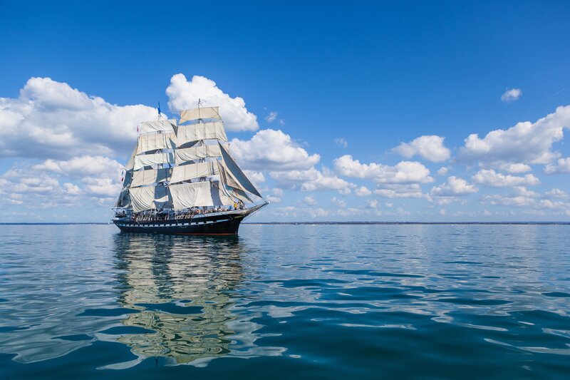 Sailboat on Calm Water — Blue, Serene, Afternoon, Photograph, Sails, Clouds