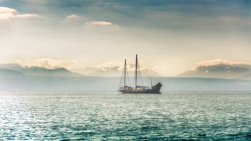 Sailboat on Calm Water — Blue, Serene, Morning, Photograph, Mountains
