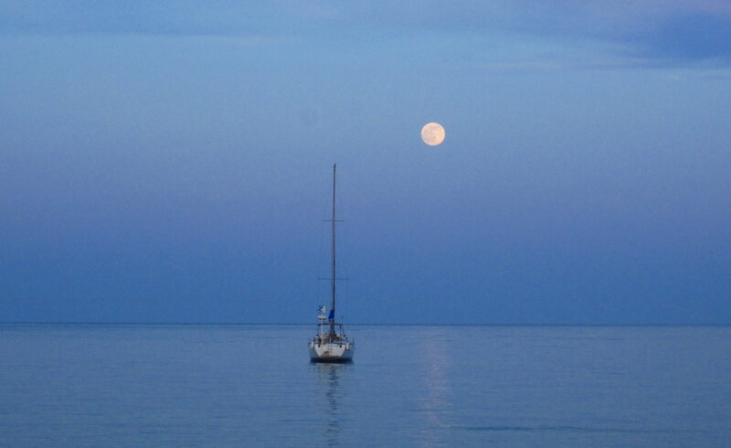 Sailboat on Calm Water — Blue, Serene, Night, Photograph