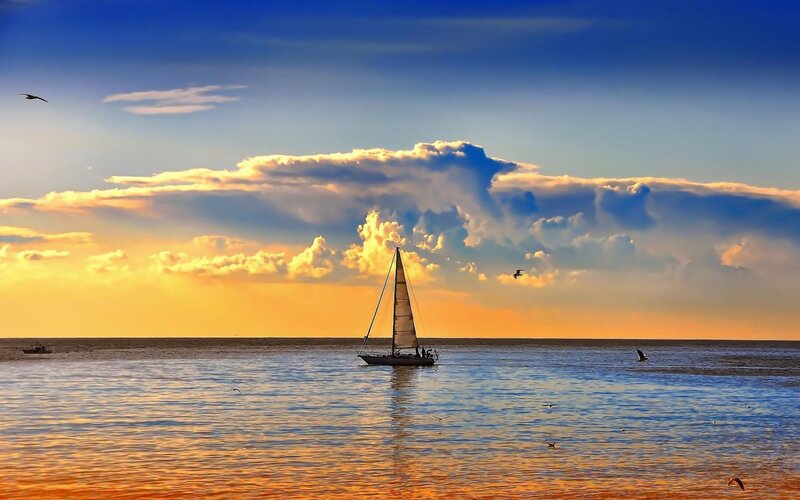 Sailboat on Calm Water — Blue, Serene, Sunset, Photograph, Clouds, Seagulls