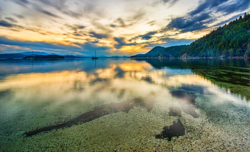 Sailboat on Calm Water — Blue, Serene, Sunset, Photograph, Mountains, Trees