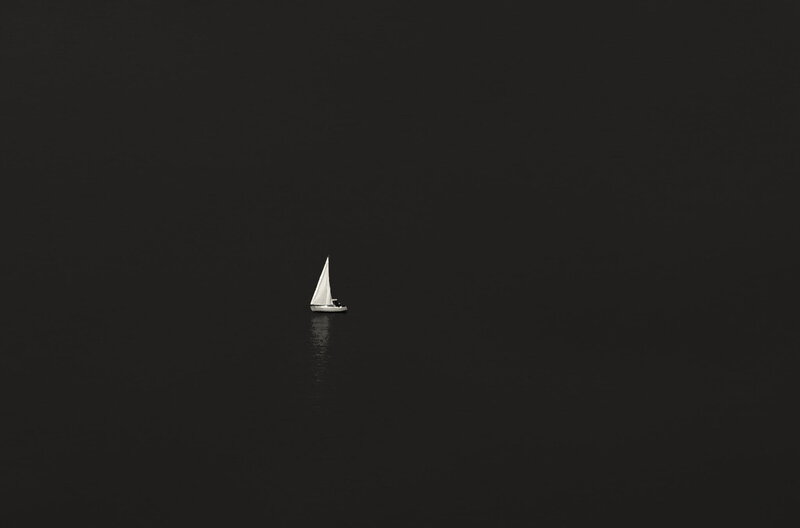 Sailboat on Dark Water — Black, Serene