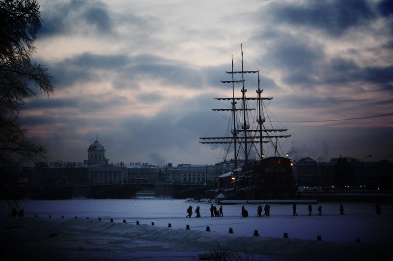 sailboat on frozen river at dusk