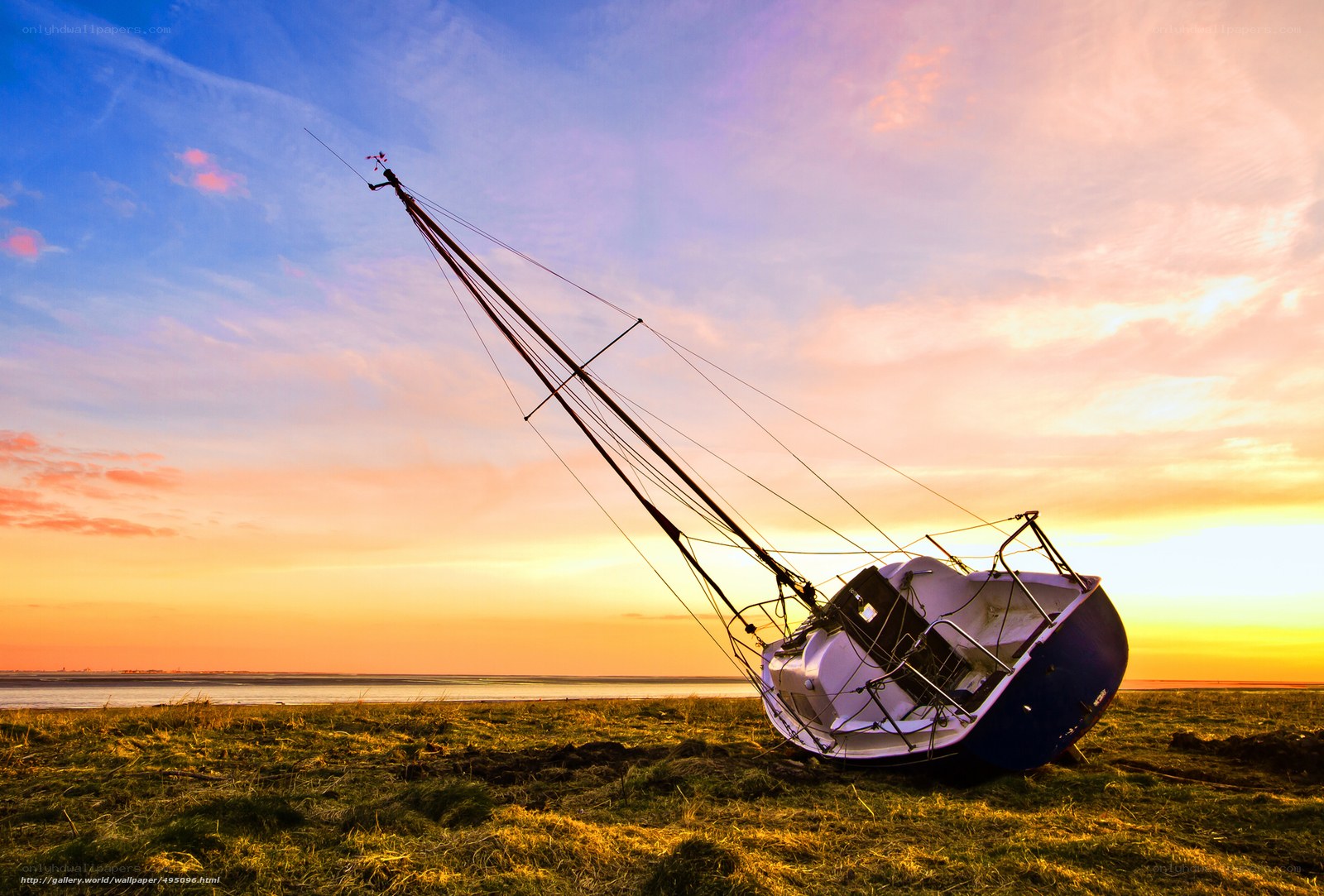 Sailboat on grass at sunset