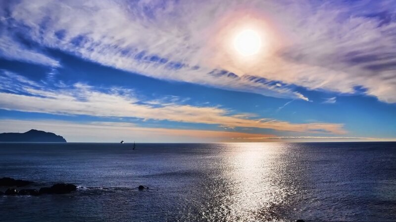 Sailboat on Ocean — Blue, Serene, Sunset, Photograph, Sun, Clouds, Island