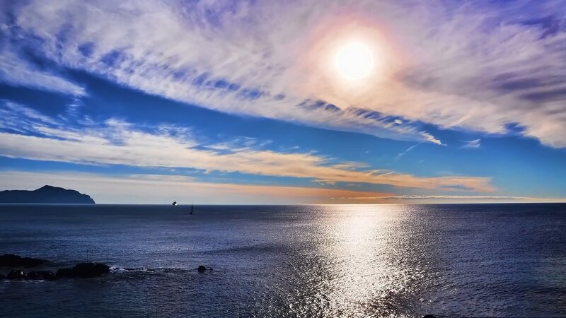 Sailboat on Ocean — Blue, Serene, Sunset, Photograph, Sun, Clouds