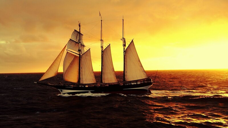 Sailboat on Ocean — Orange, Dramatic, Sunset, Photograph, Sky, Sails