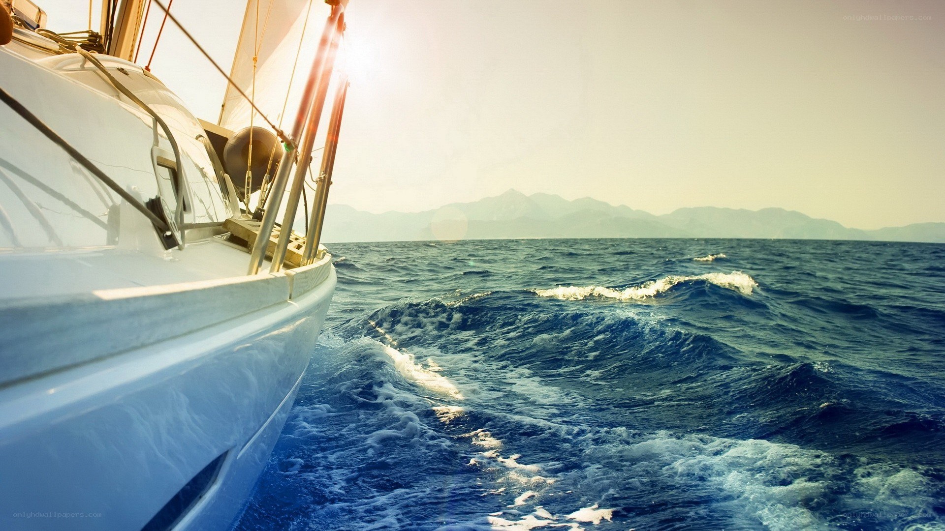 Sailboat on open sea at sunset