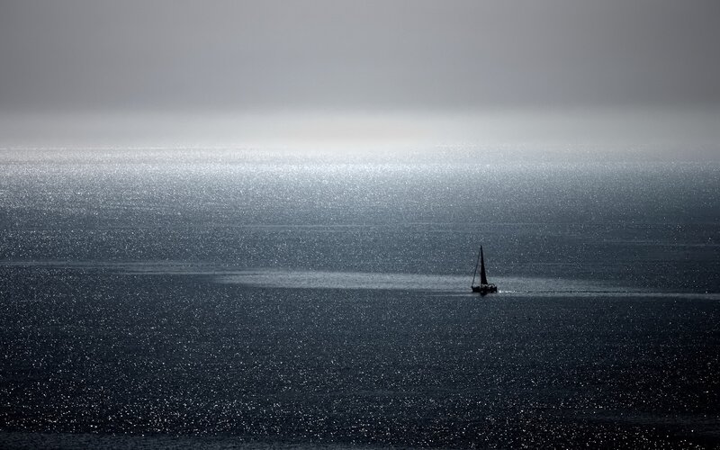 sailboat on shimmering sea