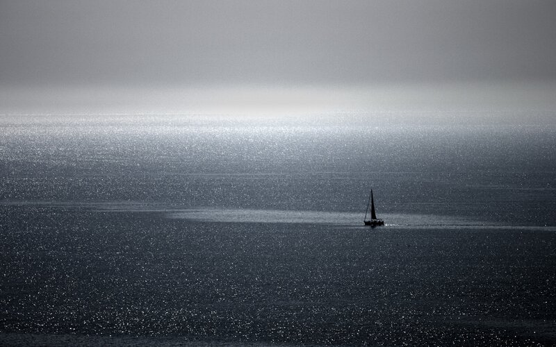 sailboat on shimmering sea