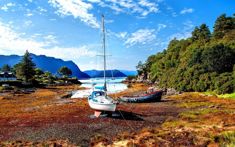 Sailboat on Tidal Flats — Blue, Serene, Afternoon