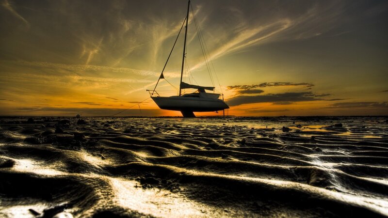 Sailboat on Tidal Flats — Orange, Dramatic, Sunset