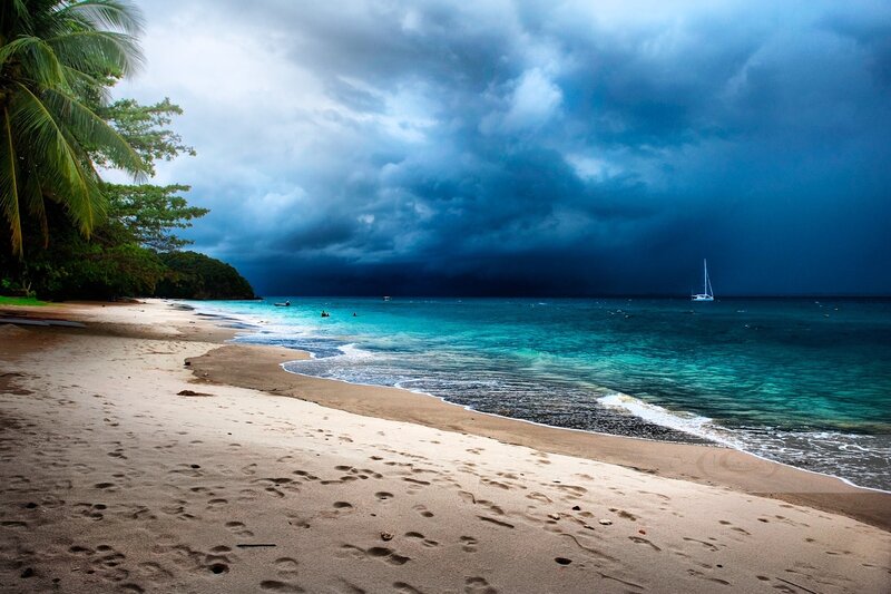 Sailboat on Tropical Beach — Blue, Dramatic