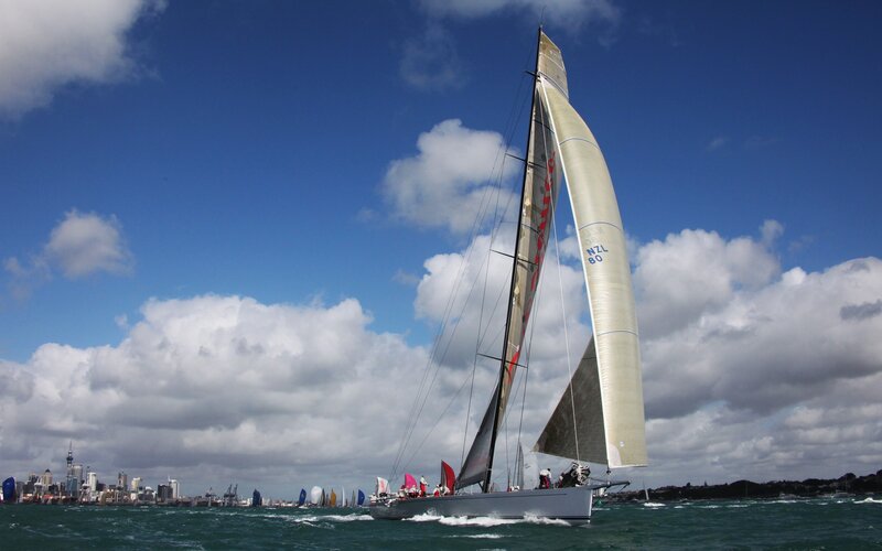 Sailboat racing in city harbor