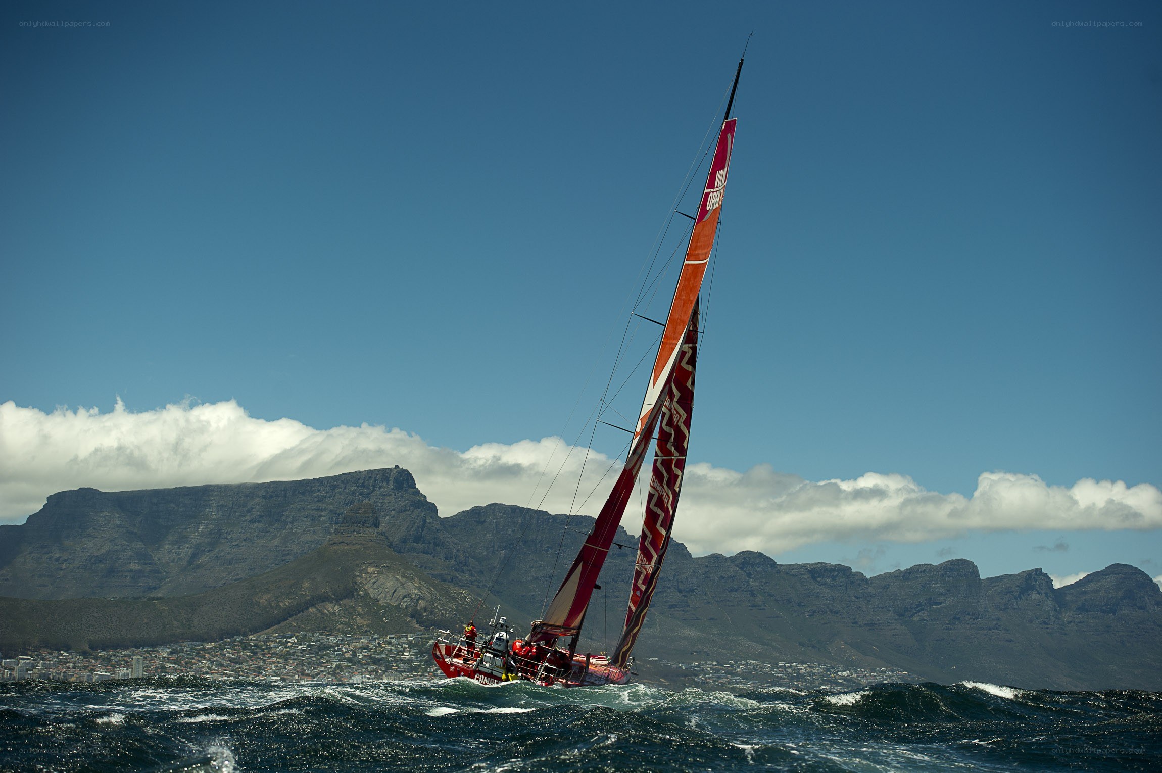 Sailboat racing near mountains
