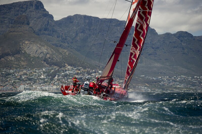 Sailboat racing near mountains