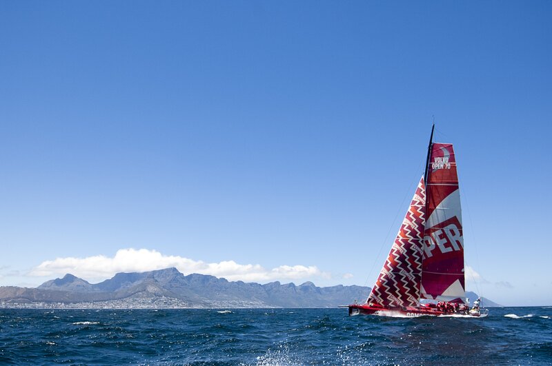 Sailboat racing near mountains