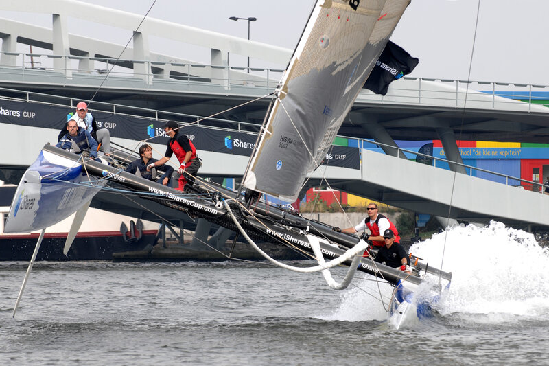 Sailboat racing under bridge