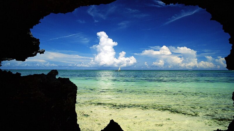 sailboat through cave opening