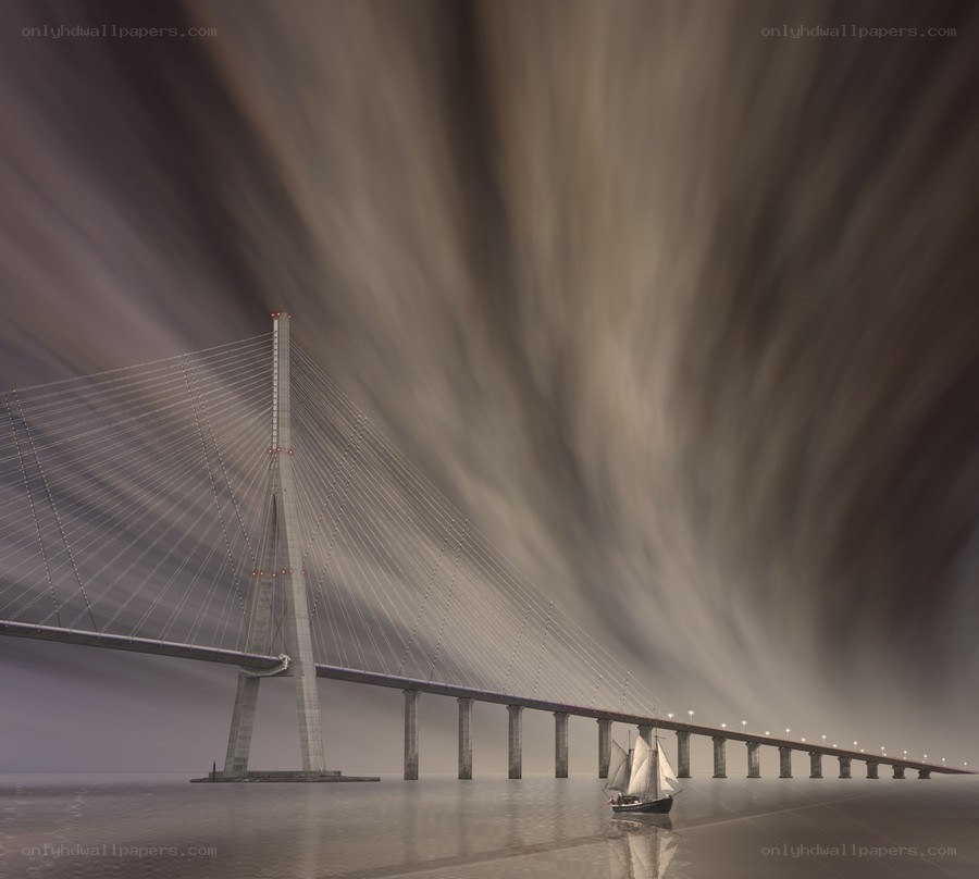 Sailboat under a modern bridge