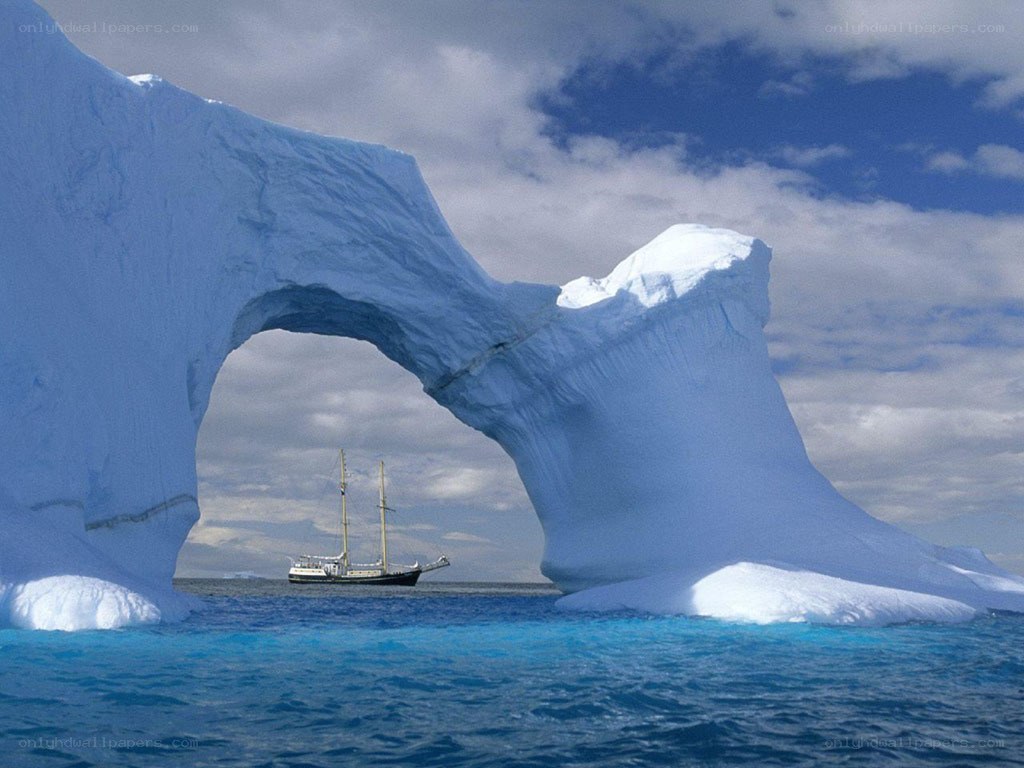 Sailboat under an iceberg arch