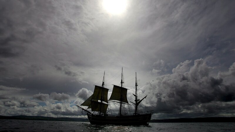sailboat under cloudy sky