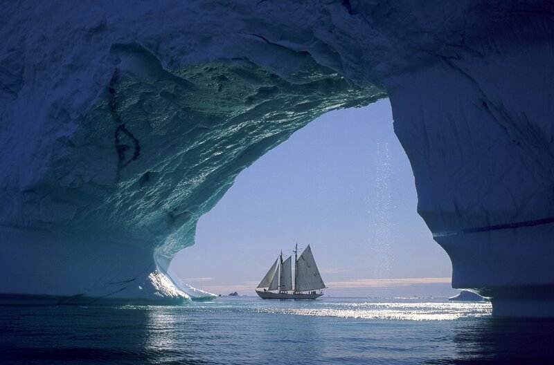 Sailboat under Ice Arch — Blue, Serene, Afternoon, Photograph, Ice Arch