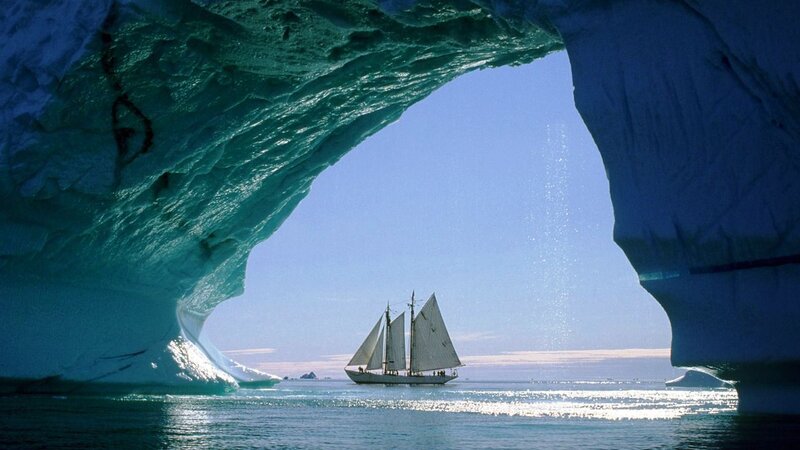 Sailboat under Ice Arch — Blue, Serene, Afternoon