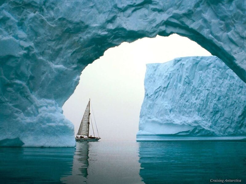 Sailboat under Iceberg Arch — Blue, Serene, Photograph
