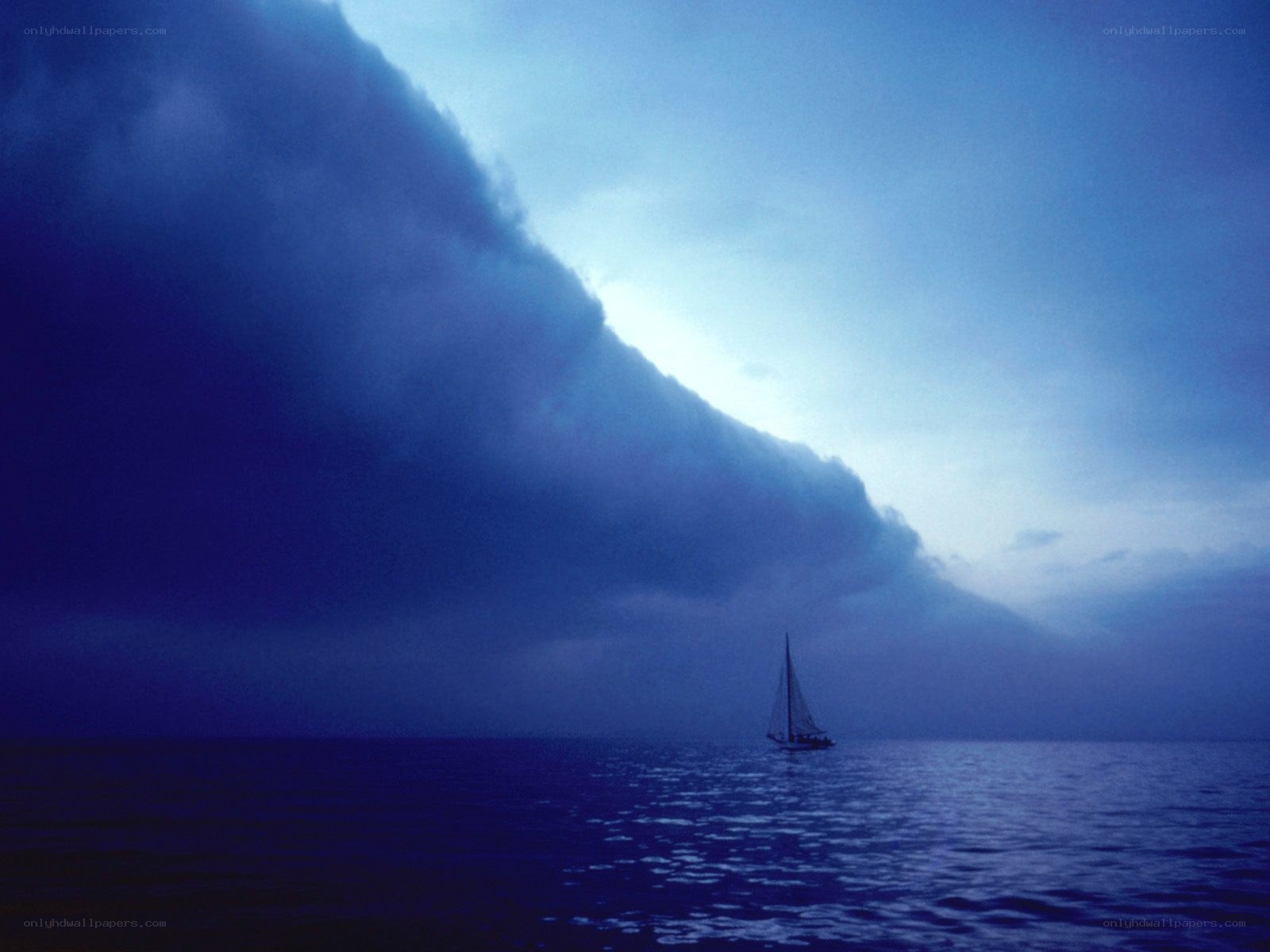 Sailboat under storm clouds
