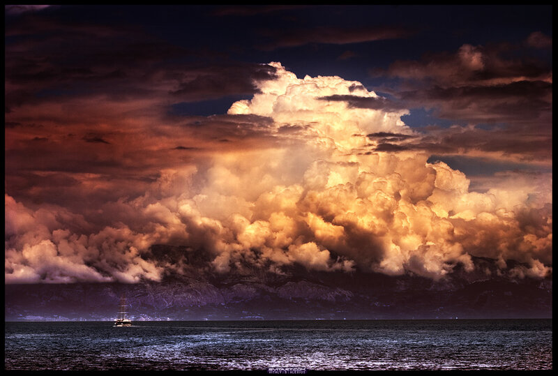 Sailboat under storm clouds