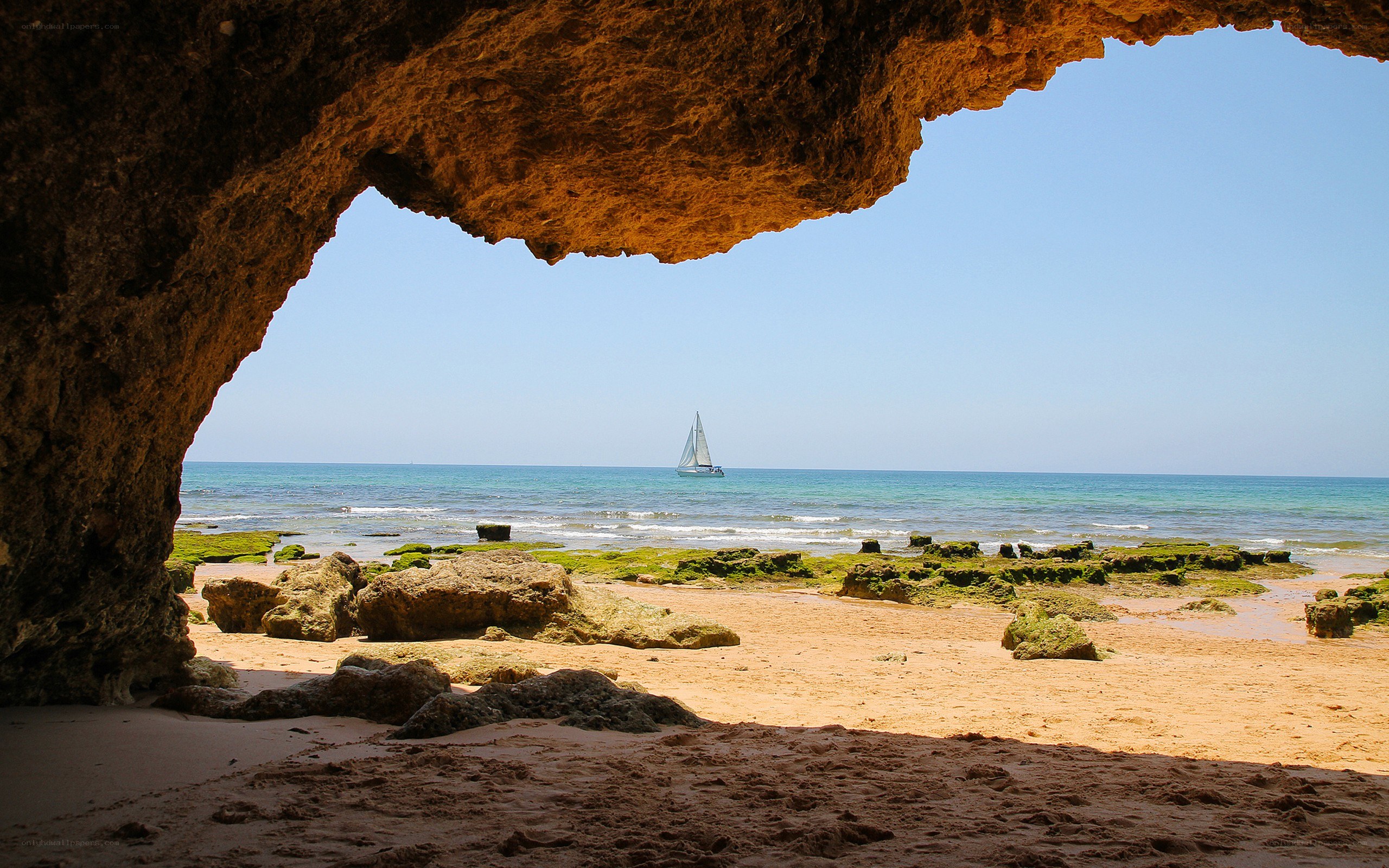 Sailboat viewed from cave