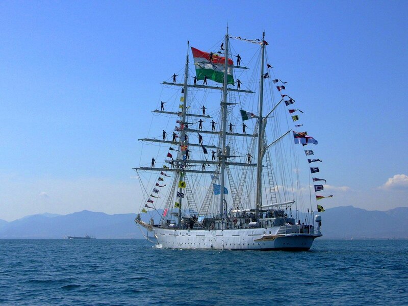 Sailboat with crew on rigging