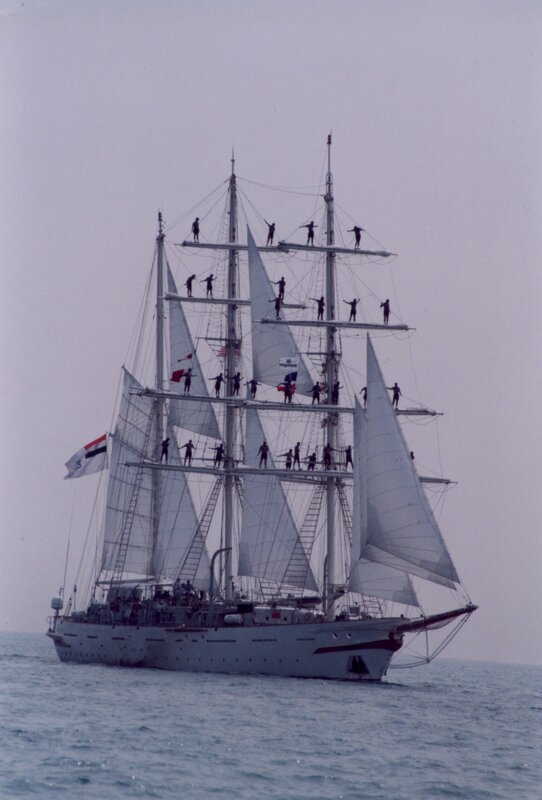Sailboat with crew on rigging