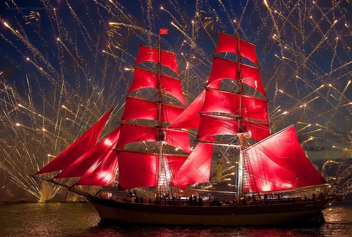 Sailboat with red sails at night